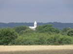 Some structure, possibly a church, poking above the trees.