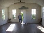 Linda enters the old one room school house.